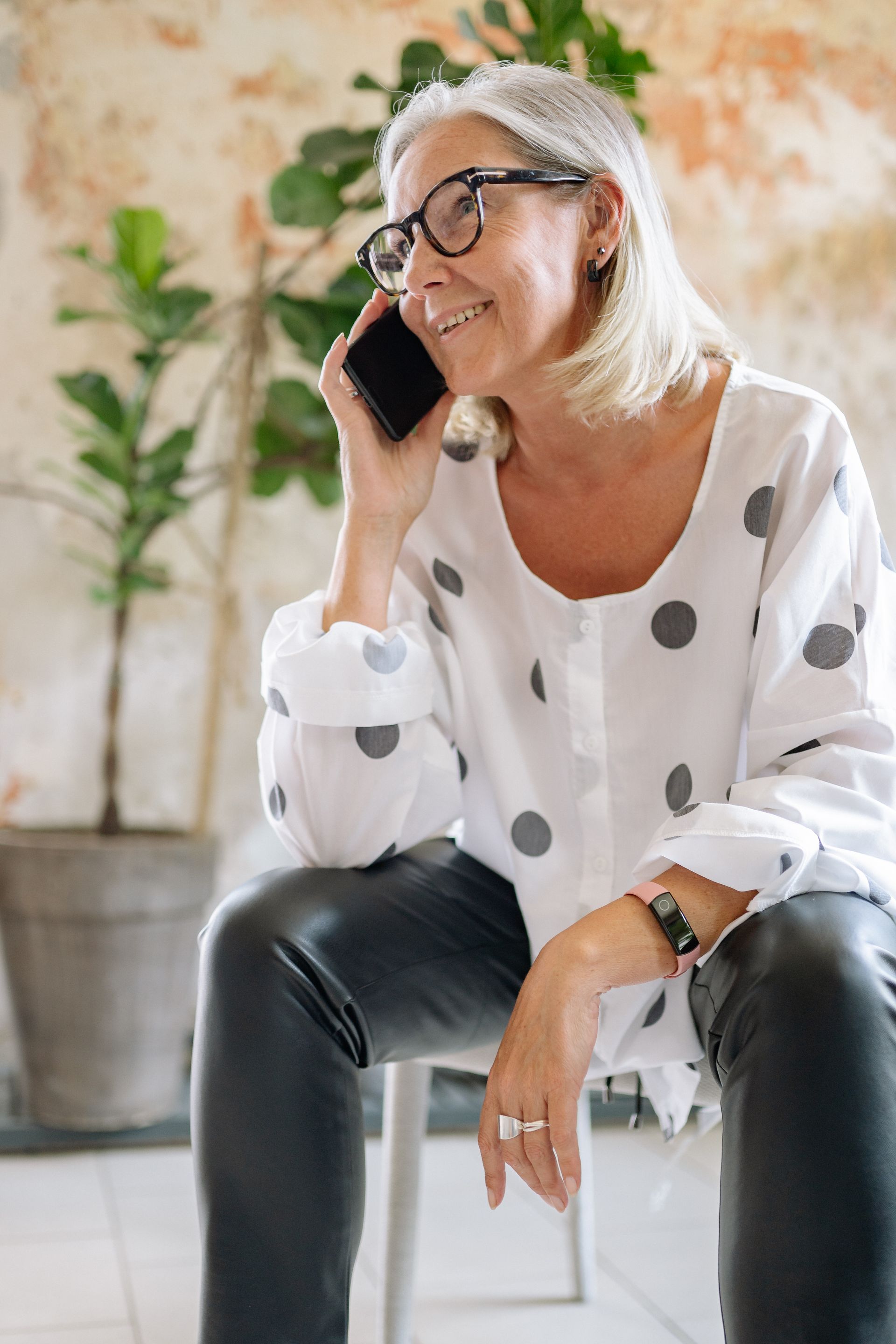 A parent smiles with visible relief while on a phone call.